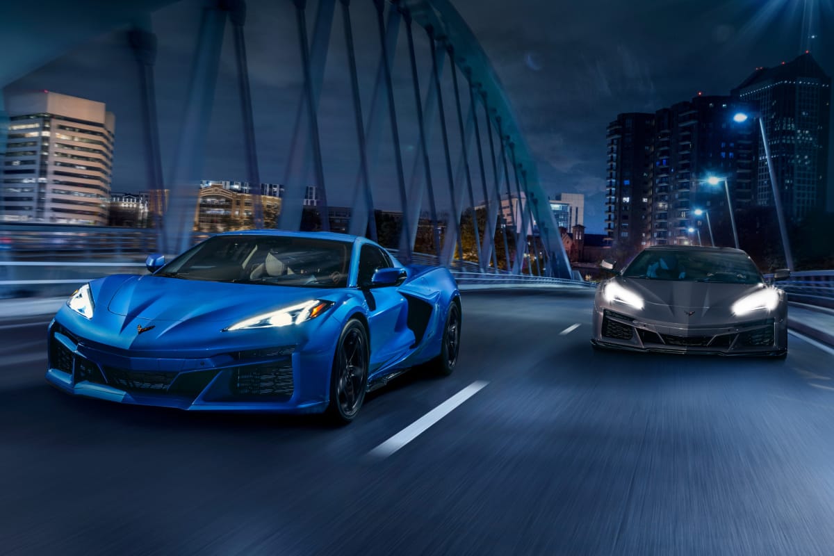 Front shot of blue & grey Corvette E-Ray's driving on city bridge