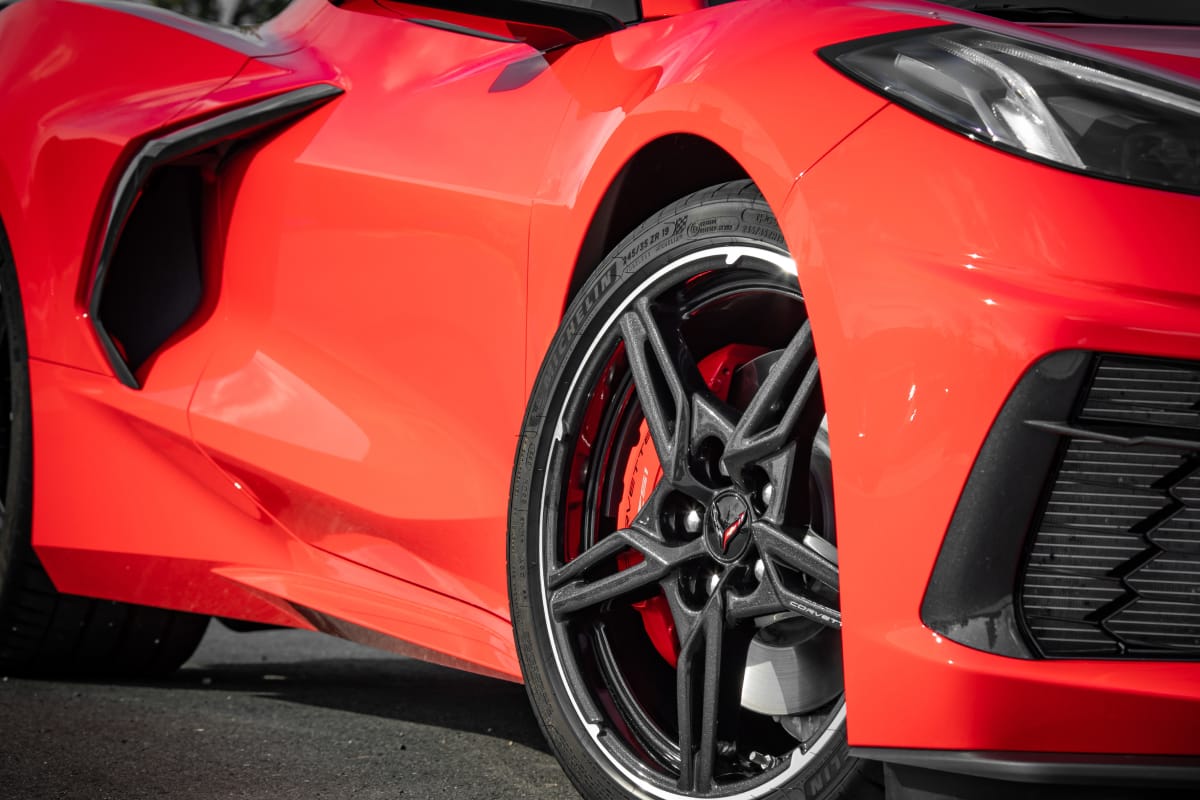 Close-up shot of red Corvette Stingray alloys and bodywork