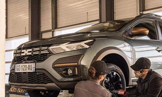 Mechanic inspecting car