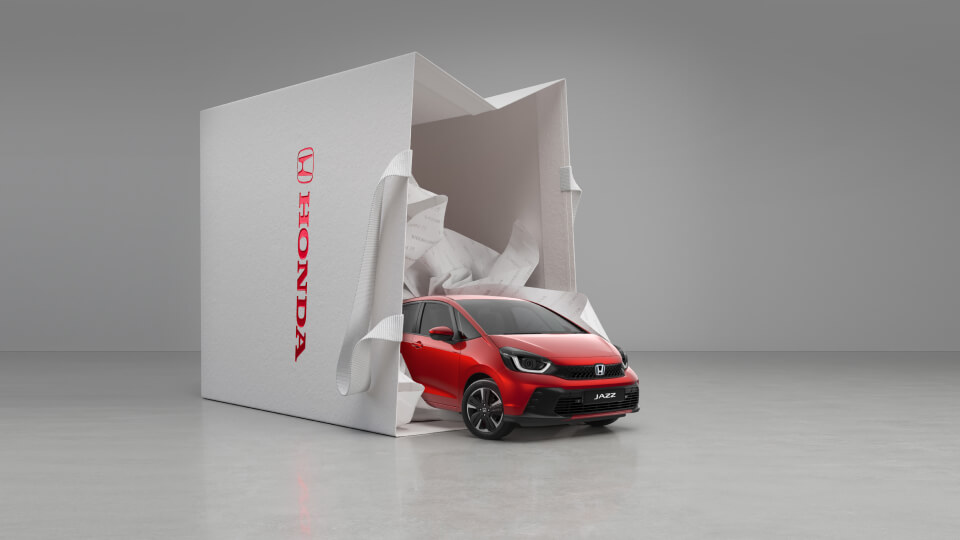 Image of a red Honda Jazz spilling out of  a shopping bag