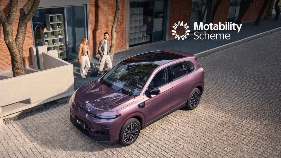 Upward angled view of Leapmotor B10 with models and Motability Scheme logo